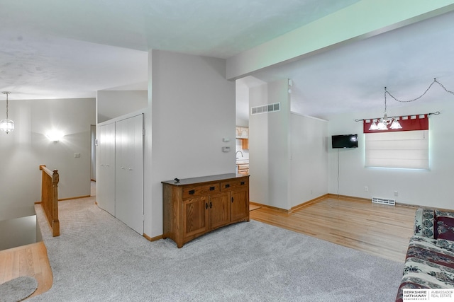 living room with light carpet and lofted ceiling with beams