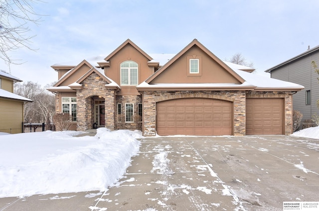 view of front of house with driveway, an attached garage, and stucco siding