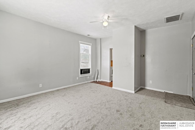 unfurnished bedroom featuring ceiling fan, carpet, and a textured ceiling