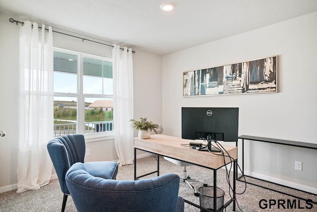 office with carpet and a textured ceiling