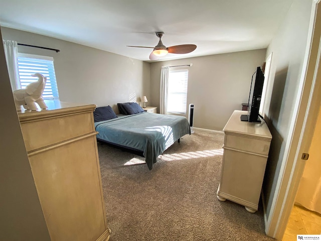 bedroom featuring light carpet and ceiling fan