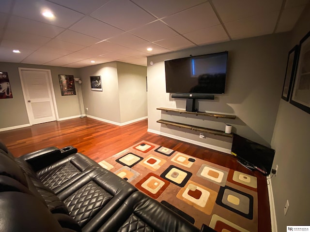 living room with a paneled ceiling and hardwood / wood-style floors