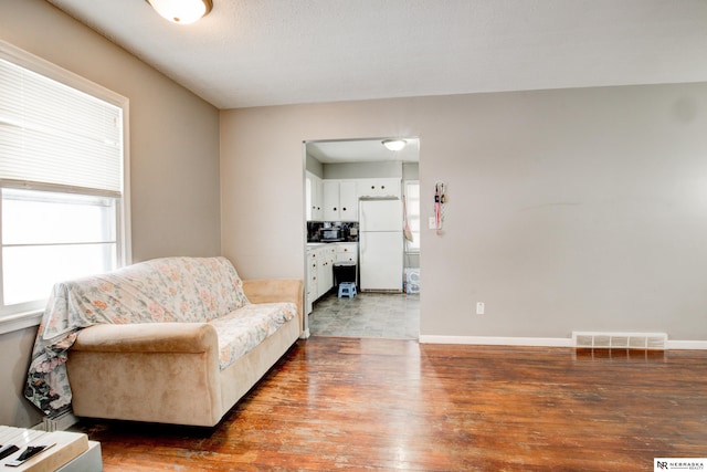 living area with hardwood / wood-style flooring