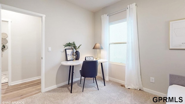 home office with light carpet and a healthy amount of sunlight