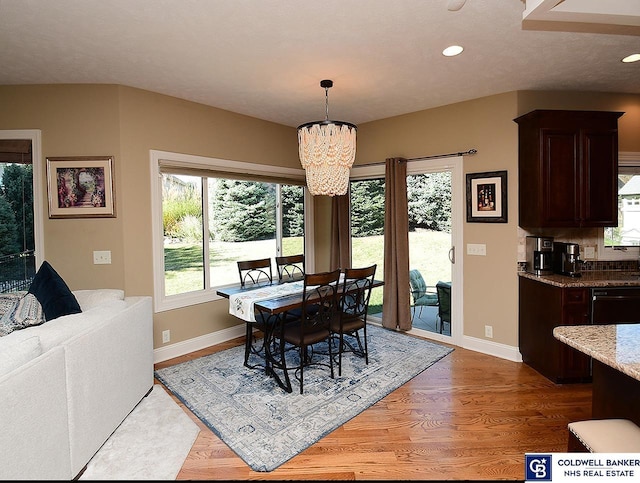 dining room featuring light hardwood / wood-style flooring and a notable chandelier