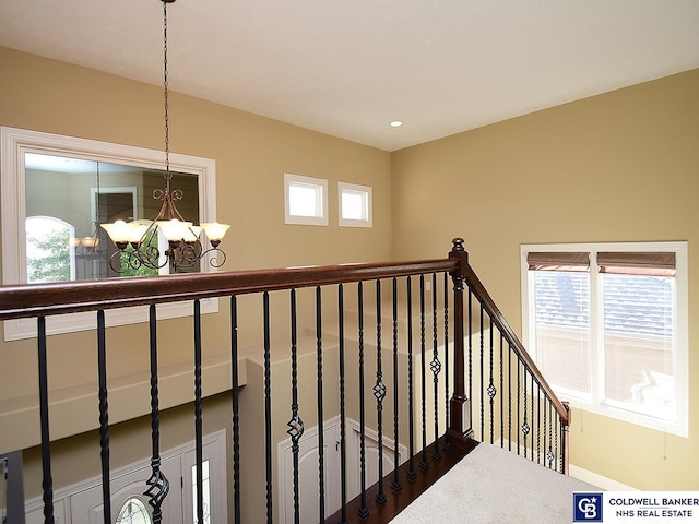 hall with a chandelier and a wealth of natural light