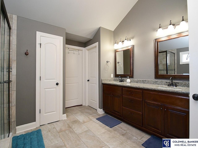 bathroom with vanity and a shower with door