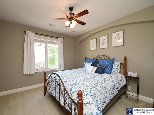 bedroom with ceiling fan and light colored carpet