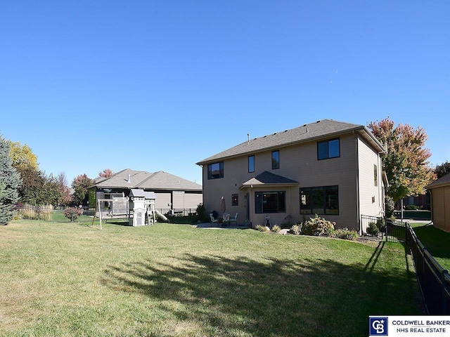 back of property featuring a lawn