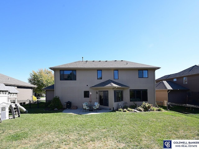 back of property with a patio and a yard