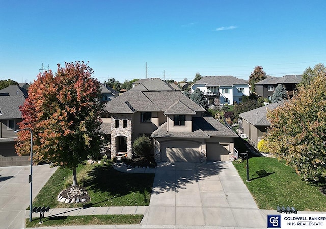 view of front of home featuring a front yard and a garage