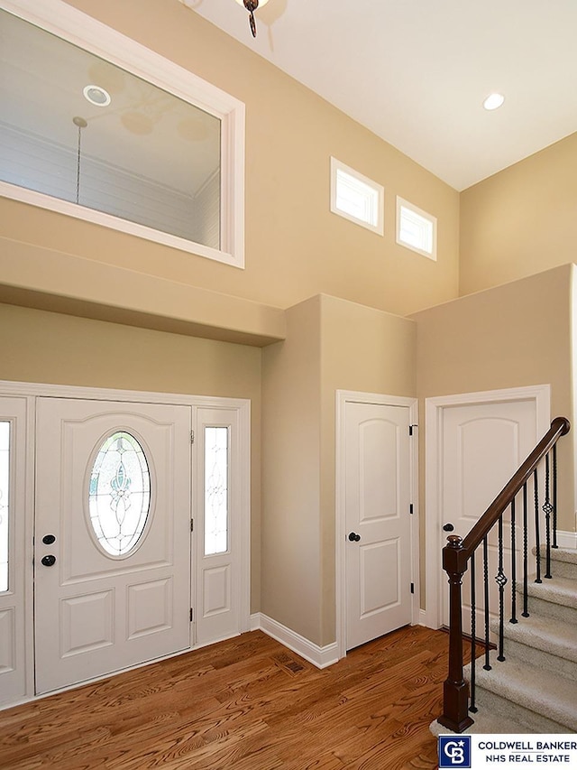 entrance foyer featuring a high ceiling and hardwood / wood-style floors