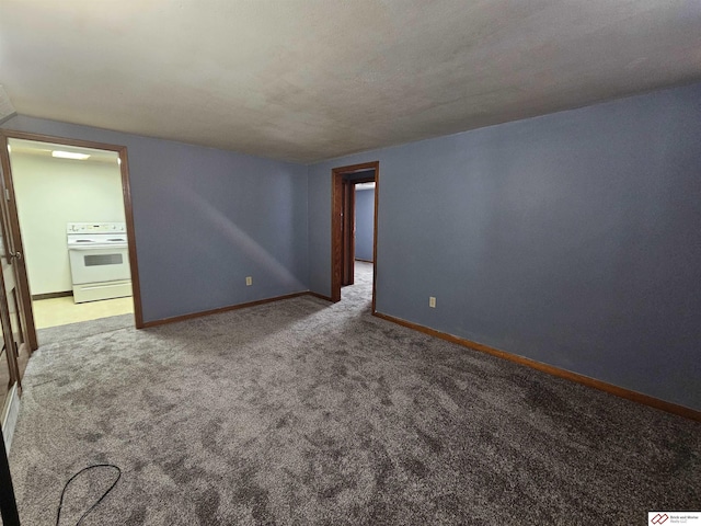 carpeted spare room with baseboards