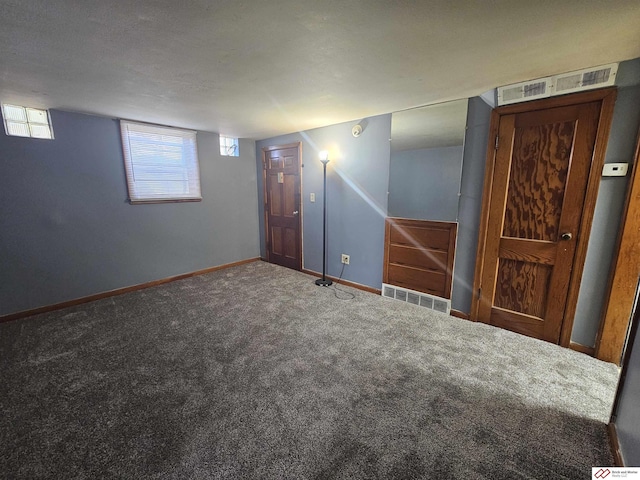 interior space featuring visible vents, baseboards, and carpet floors