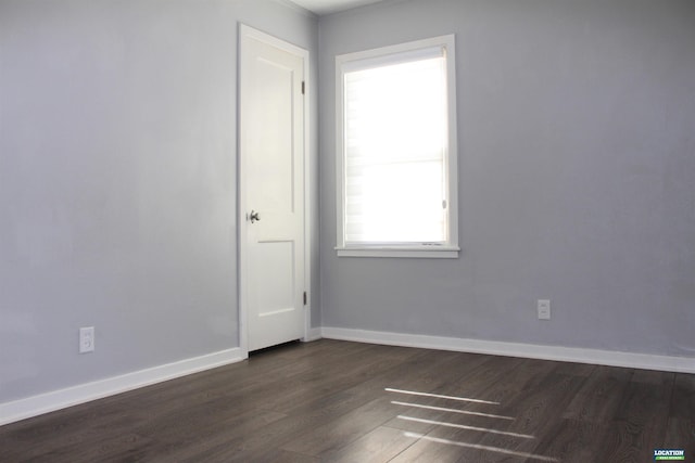 unfurnished room featuring dark wood finished floors and baseboards