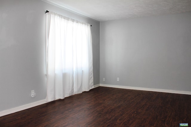 unfurnished room with dark wood-style floors and baseboards