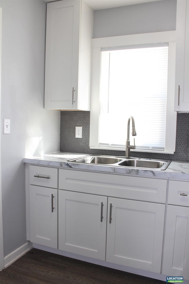 kitchen with a sink, plenty of natural light, white cabinets, and light countertops