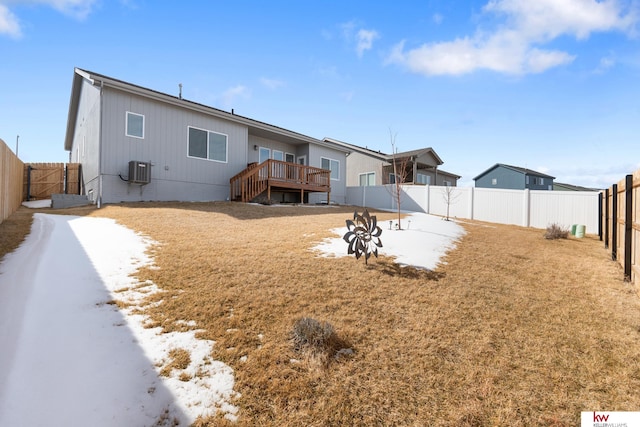 rear view of house with a deck, central AC, and a fenced backyard