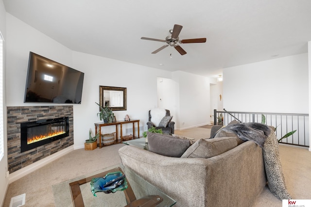 living area with light carpet, a fireplace, visible vents, and a ceiling fan