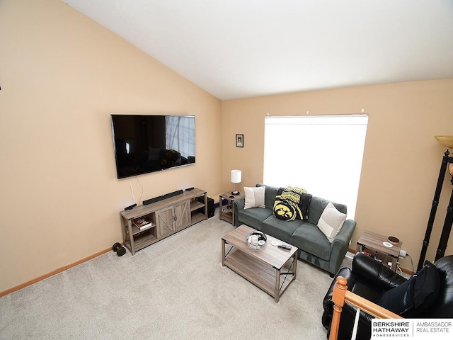 carpeted living room featuring lofted ceiling