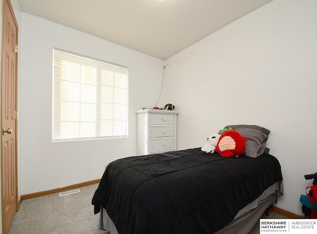 bedroom featuring lofted ceiling and carpet