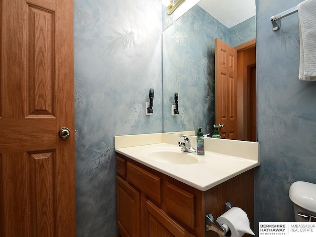 bathroom featuring vanity and toilet