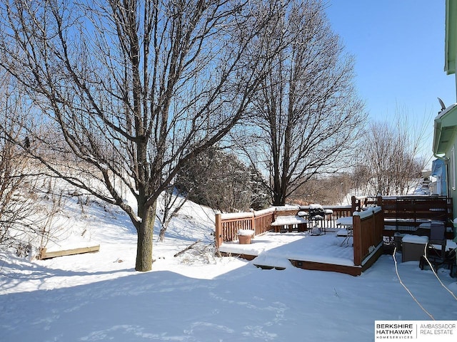 snowy yard with a wooden deck