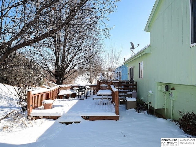 snowy yard with a deck