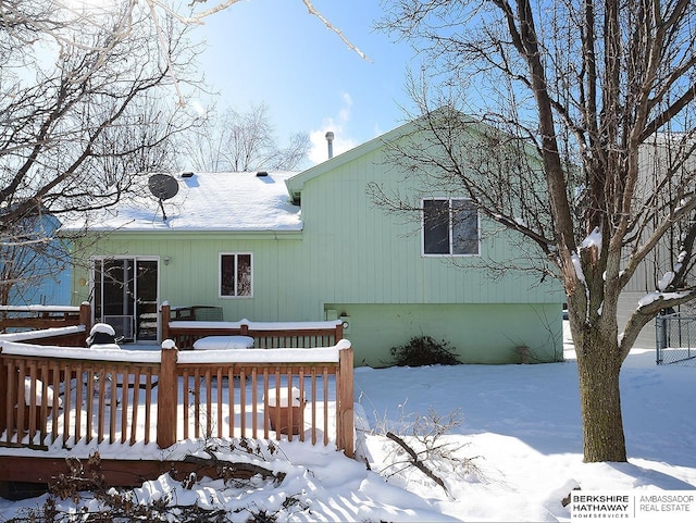 view of snow covered rear of property