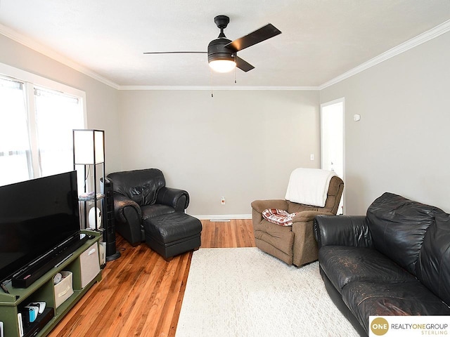 living room featuring ornamental molding, ceiling fan, and hardwood / wood-style floors