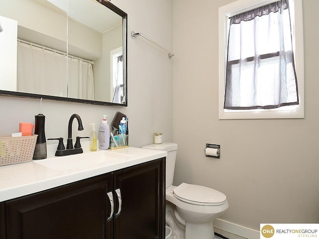 bathroom featuring toilet and vanity