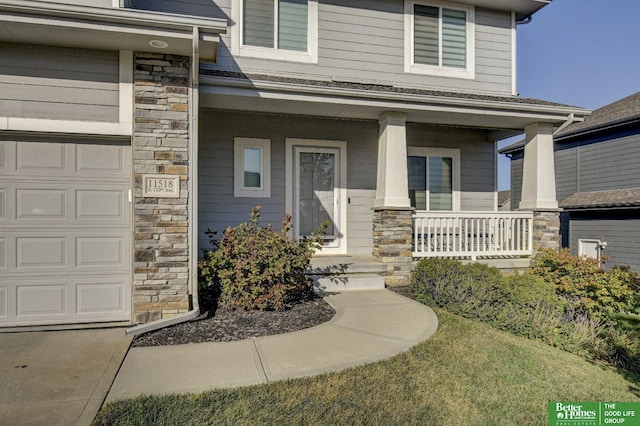 entrance to property with a porch and a garage