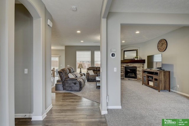 interior space with hardwood / wood-style floors and a stone fireplace