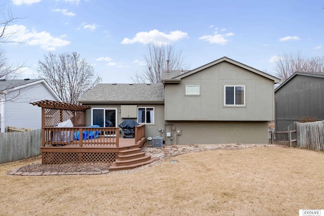 rear view of property with central AC unit, a wooden deck, a lawn, and a fenced backyard