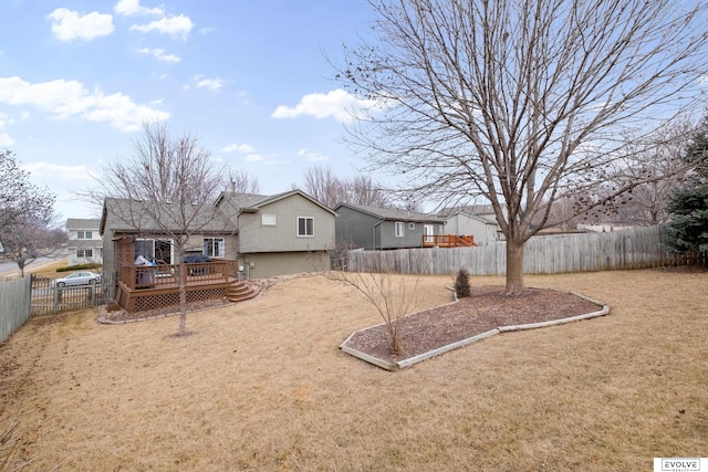 view of yard featuring a wooden deck and a fenced backyard