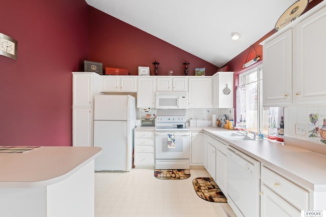 kitchen with white cabinets, light countertops, and white appliances