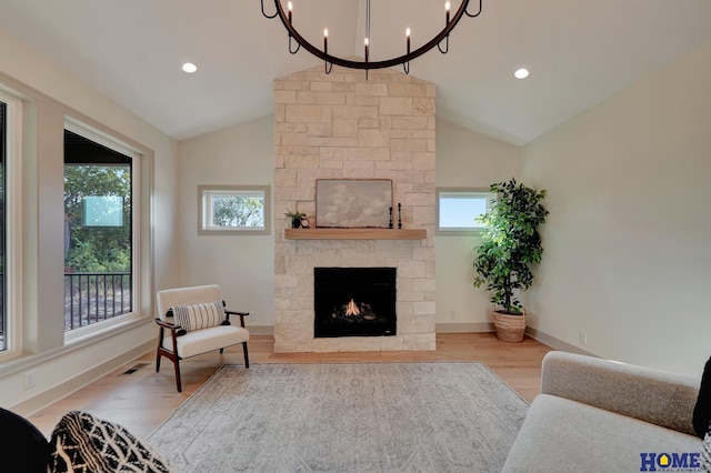 living area with a wealth of natural light, light wood finished floors, visible vents, and a fireplace