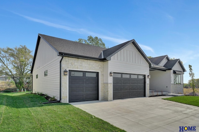 view of front facade with stone siding, a front lawn, board and batten siding, roof with shingles, and a garage