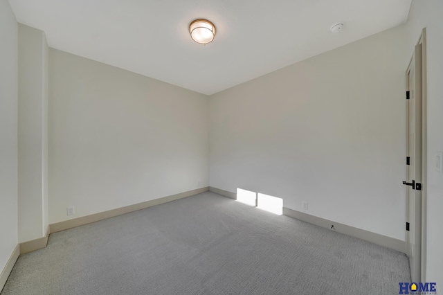 empty room with baseboards and light colored carpet