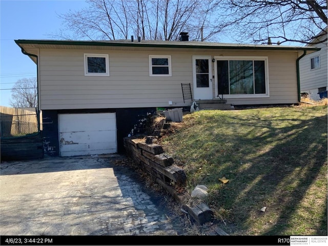 single story home with a garage, driveway, entry steps, fence, and a front lawn