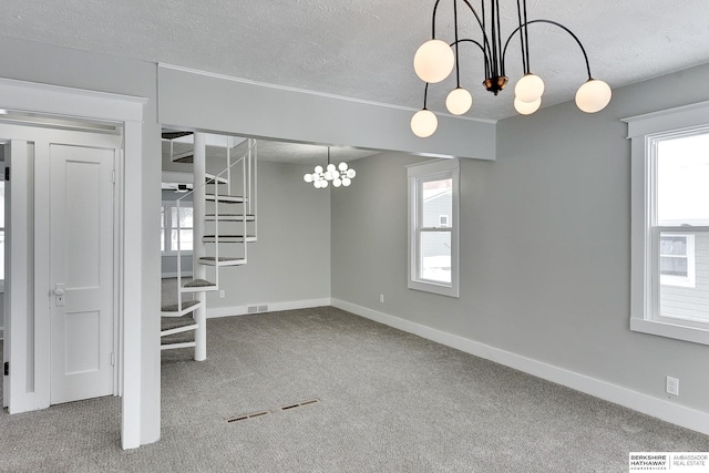 unfurnished dining area featuring baseboards, visible vents, carpet flooring, and a textured ceiling