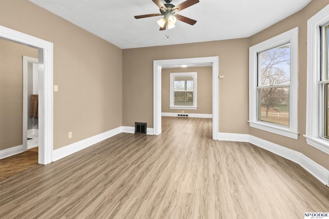 spare room with light wood-style flooring, baseboards, and visible vents