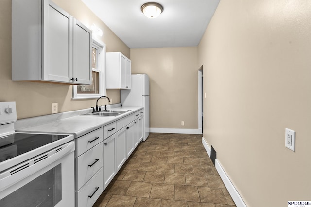 kitchen featuring baseboards, a sink, light countertops, white appliances, and white cabinets