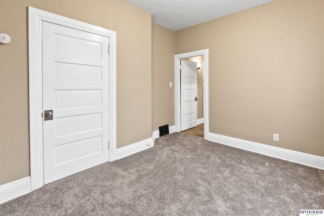 unfurnished bedroom featuring baseboards and carpet