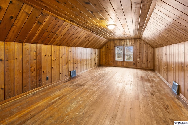 additional living space with vaulted ceiling, visible vents, wooden ceiling, and wood finished floors