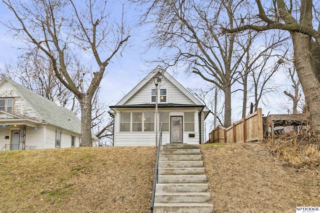 view of front of home featuring a sunroom