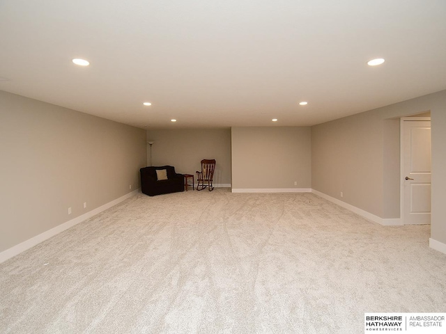 finished basement featuring recessed lighting, light colored carpet, and baseboards