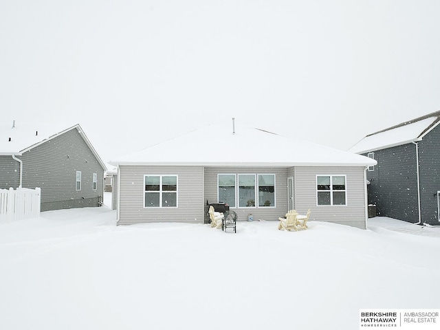 view of snow covered rear of property