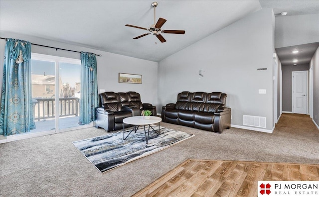 living area with visible vents, carpet flooring, ceiling fan, high vaulted ceiling, and baseboards