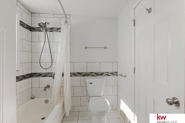 bathroom with visible vents, toilet, shower / tub combo with curtain, tile patterned flooring, and tile walls